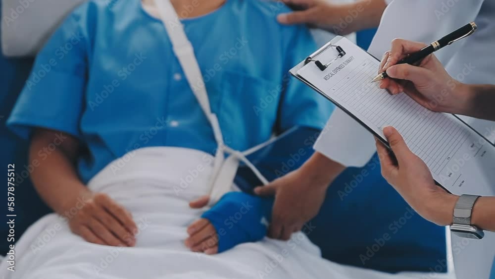 Man with broken arm in cast lying on bed in hospital. The emergency center treatment is plaster and hangs with sling for a further cure in an orthopedic clinic. Patient pain from accident injury. Man with broken arm in cast lying on bed in hospital. The emergency center treatment is plaster and hangs with sling for a further cure in an orthopedic clinic. Patient pain from accident injury.