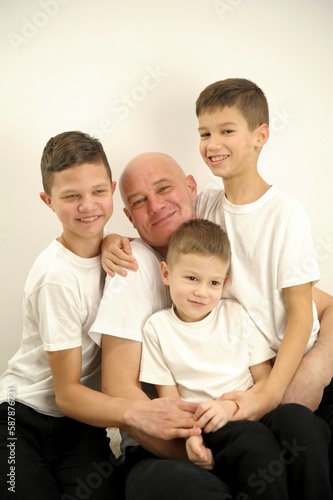 dad with his sons on a white background. High quality photo