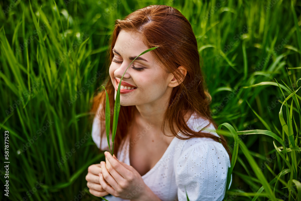 happy woman on vacation sitting in tall grass happy woman on vacation sitting in tall grass