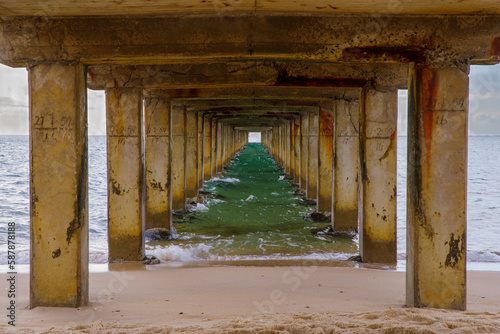 under the pier at the beach