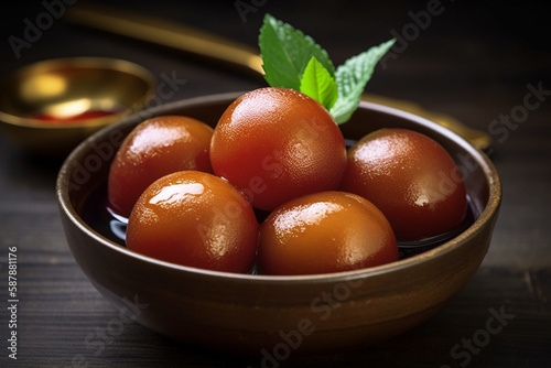 Gulab jamun are soft delicious berry sized balls made with milk solids, flour & leaning agent. these are soaked in rose flavored sugar syrup & enjoyed photo