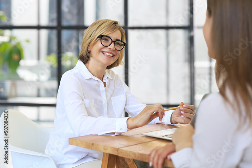 Professional middle aged female psychologist conducting a consultation.