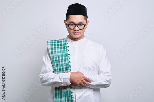 Young asian muslim man doing praying gesture 