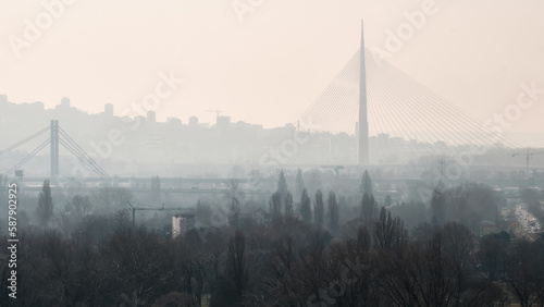 View of Ada Bridge and panorama of Belgrade in the misty morning. The Ada Bridge is a cable-stayed bridge over the Sava river in Belgrade, Serbia photo