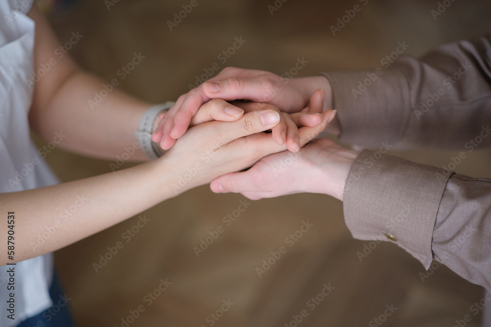 two women holding hands, emphasizing the importance of self-care and emotional well-being. The concept highlights the benefits of relaxation aids and therapeutic activities such as yoga, meditatio