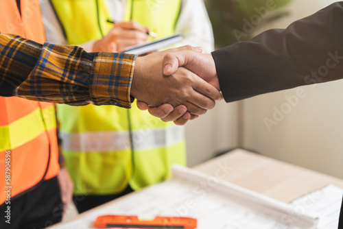 Successful team building asian young woman, man or builder group handshake together at office after home project done, good deal. Happy business people, Worker meeting, shaking hands and success.
