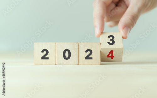 Starting new year 2024. Flipping of 2023 to 2024 on wooden cube blocks. Beginning and start of the new year 2024. Preparation for new year ,life, business, plan, goals, target and strategy concept.