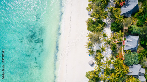 Escape to a tropical paradise with a picture-perfect beach featuring white sand, swaying palm trees, and crystal-clear turquoise waters against a blue sky with fluffy clouds on a sunny summer day. 