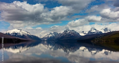 Timelapse Lockdown Of Billowing Morning Clouds Passing Over A Beautiful Lake With A Mountain Background - Glacier National Park, Montana