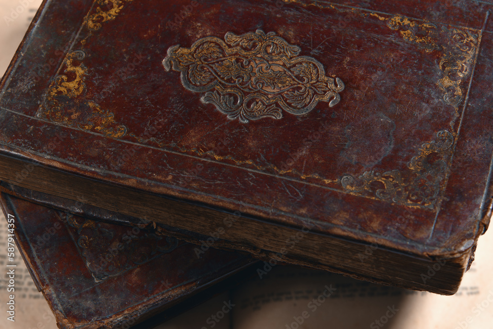 Leather bound books with gold embossing. Torah book on open pages of old jewish book. Education and religion concept. Closeup. View from above.