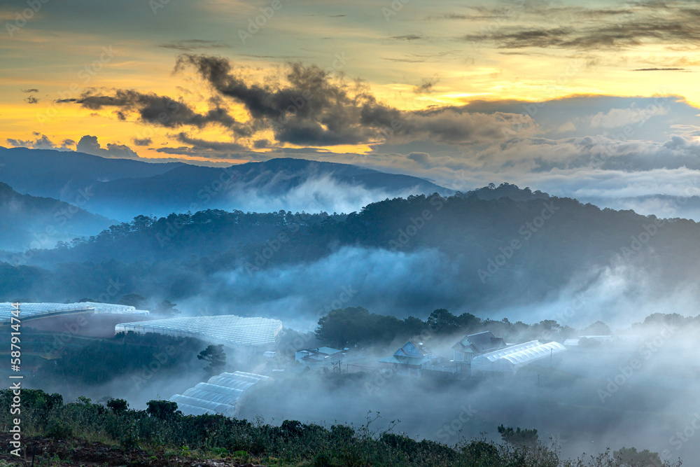 Fototapeta premium Beautiful images of the radiant dawn with reflecting rays through the fanciful clouds on over the pine forests, which created an impressive breathtaking scene of highlands in the morning in Dalat, VN