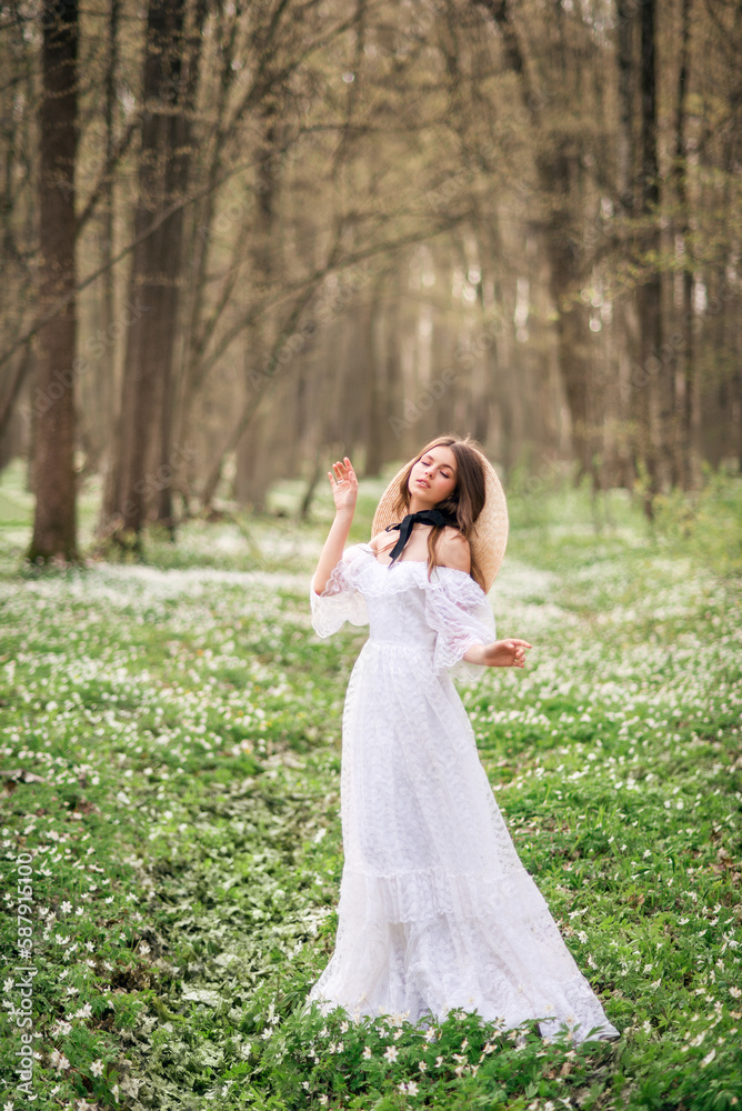 girl in a white long dress in a spring forest. Forest nymph