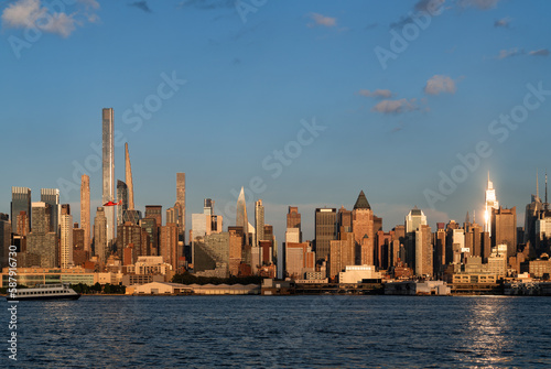 New York Manhattan skyline at sunset, business skyscrapers and golden hour © ImageFlow
