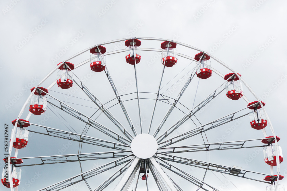 Ferris wheel amusment park. Stormy clouds in the background. Rainy weather ruining festival day in fun park. Funfair adventure background. Ferris wheel amusment park. Stormy clouds in the background. Rainy weather ruining festival day in fun park. Funfair adventure background.