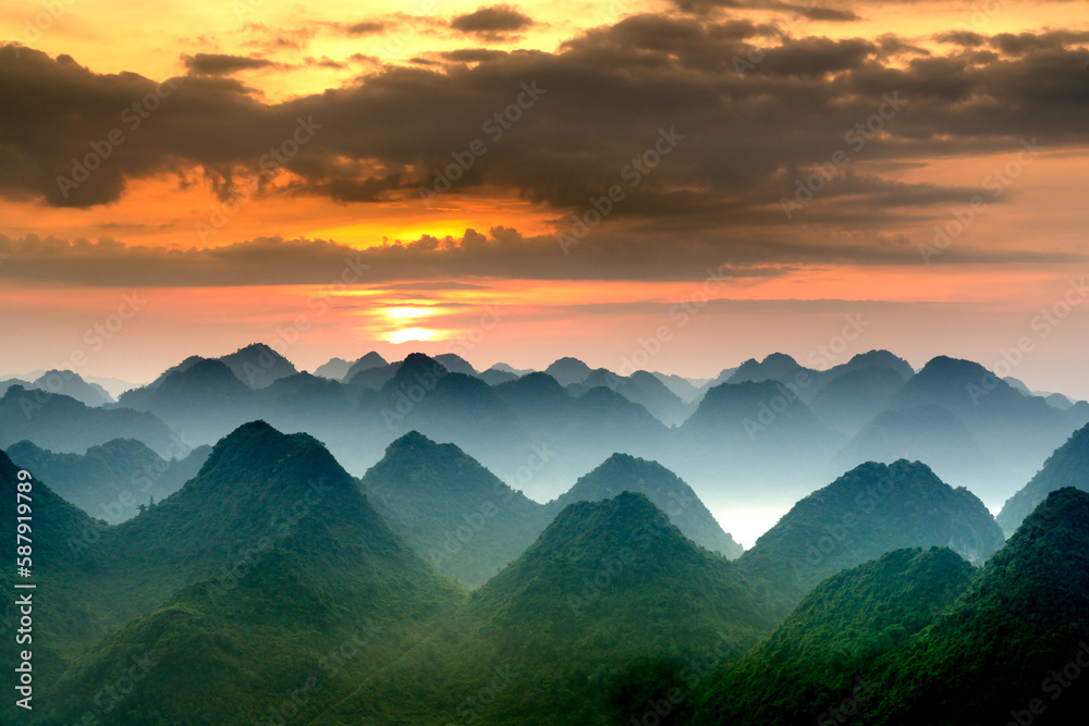 Obraz premium The magical scene of the mountains resemble the successive message they are covered with layers of lush green vegetation at dawn in Bac Son district Lang Son Province, Vietnam