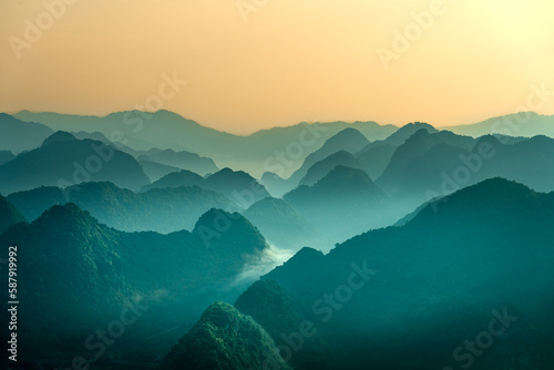 The magical scene of the mountains resemble the successive message they are covered with layers of lush green vegetation at dawn in Bac Son district Lang Son Province, Vietnam