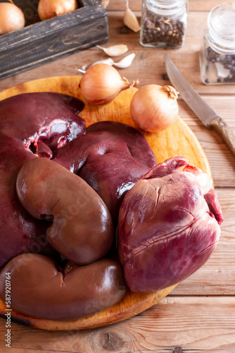 Raw fresh pork liver, kidneys, heart on the table. Offal. Ready to cook.