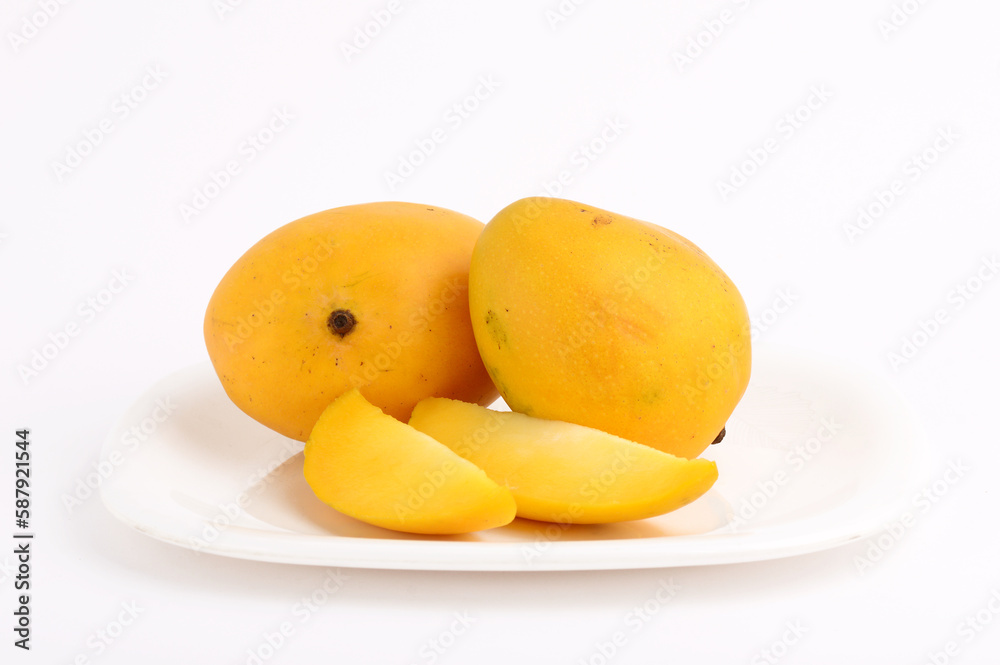 Mango fruit in basket with slice on white background