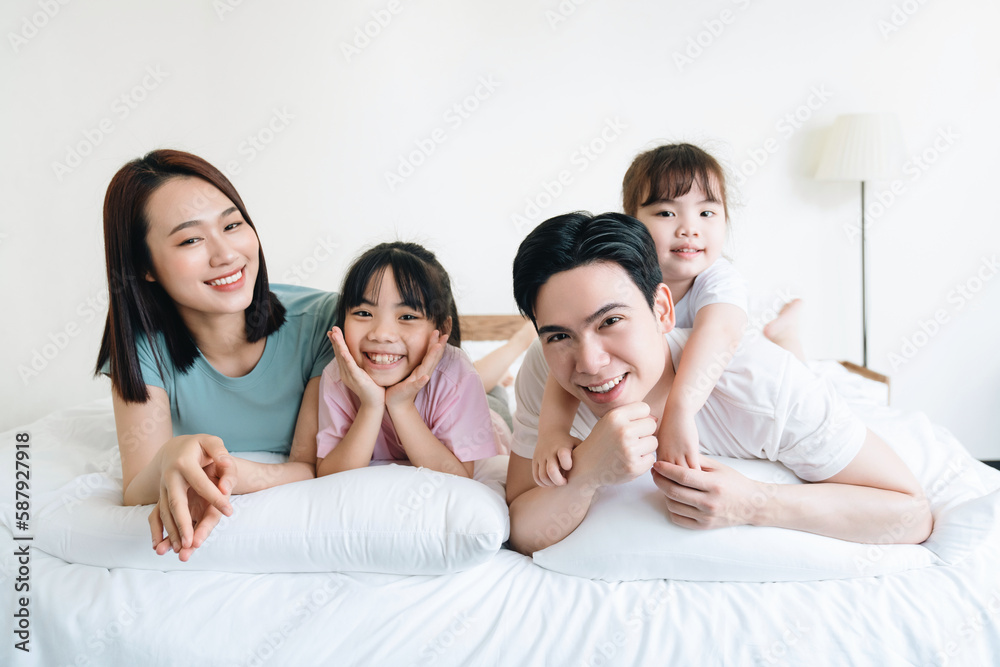 Young Asian family on bed Young Asian family on bed