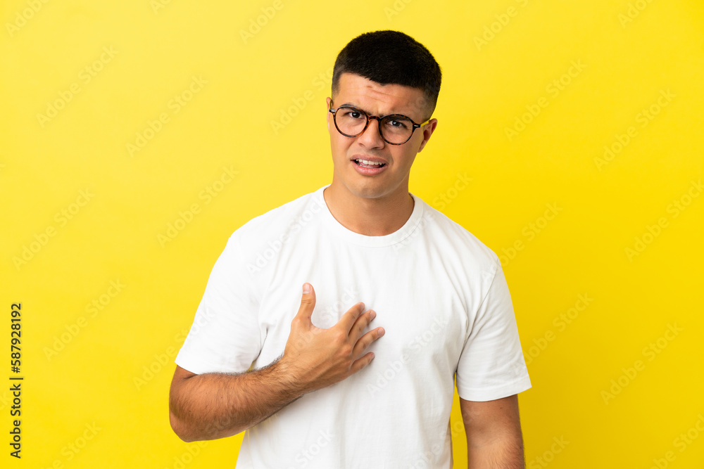 Young handsome man over isolated yellow background pointing to oneself Young handsome man over isolated yellow background pointing to oneself