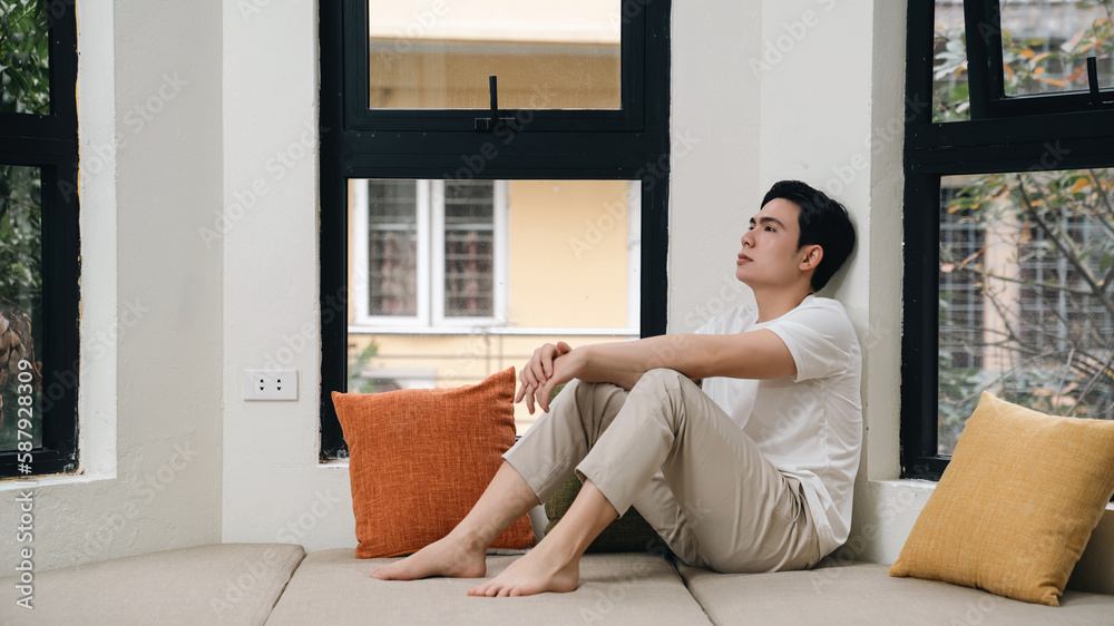 Image of young Asian man at home Image of young Asian man at home