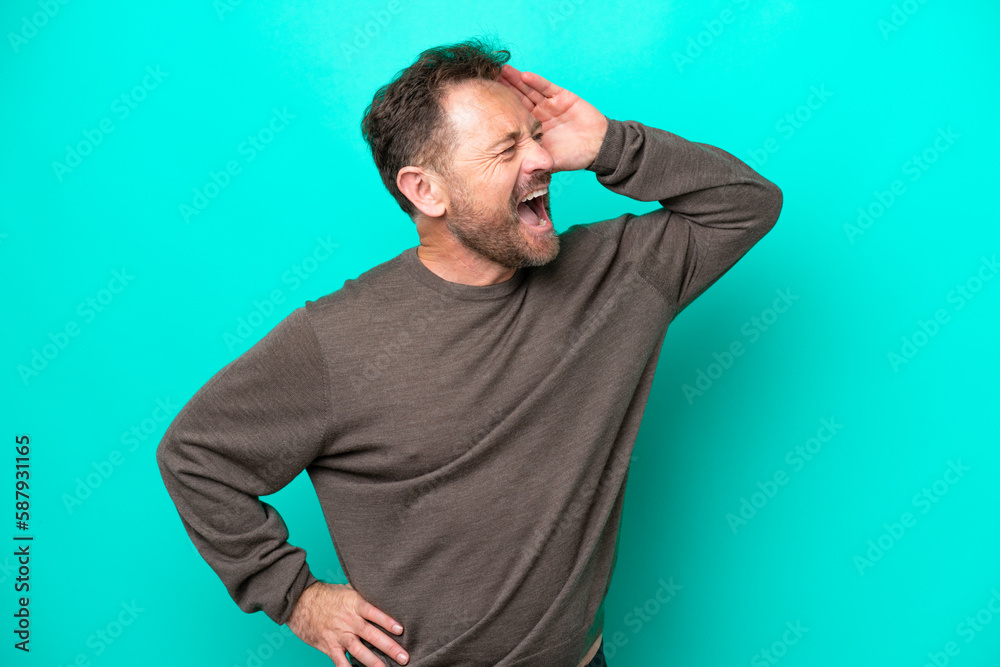 Middle age caucasian man isolated on blue background smiling a lot Middle age caucasian man isolated on blue background smiling a lot