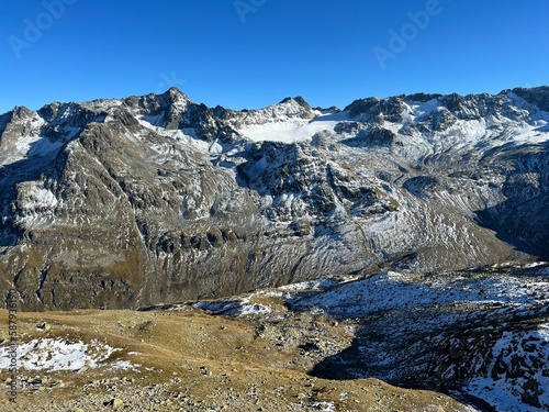 First autumn snow on the rocky peaks in the mountainous area of the Albula Alps and above the Swiss mountain road pass Fluela (Flüelapass), Zernez - Canton of Grisons, Switzerland (Schweiz) photo