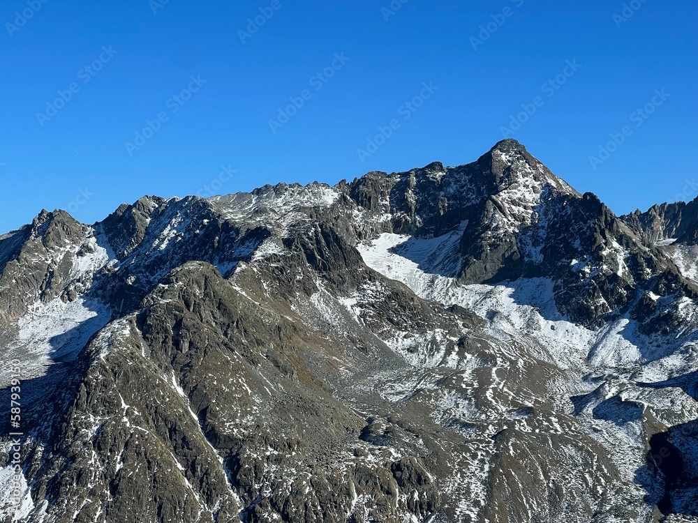 First snow on the rocky mountain peak Piz Sarsura Pitschen (3132 m) in the Albula Alps and above the alpine valley Val Grialetsch, Zernez - Canton of Grisons, Switzerland (Kanton Graubünden, Schweiz) First snow on the rocky mountain peak Piz Sarsura Pitschen (3132 m) in the Albula Alps and above the alpine valley Val Grialetsch, Zernez - Canton of Grisons, Switzerland (Kanton Graubünden, Schweiz)