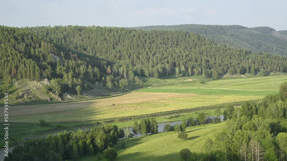 Time lapse of beautiful nature of Bashkortostan and rural field with tractor collecting dry hay. Growing shades during the time