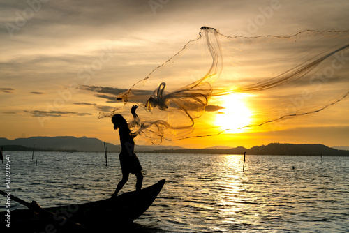 Fishermen are throwing fishing nets into on the river in the sunset in Phu Yen province, Vietnam