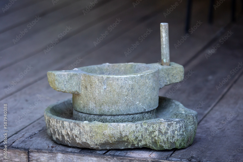 The antique Milling Stone in The kitchen of the Tay people (ethnic minorities) in Thuong Lam and Na Hang communes, Tuyen Quang province, Vietnam The antique Milling Stone in The kitchen of the Tay people (ethnic minorities) in Thuong Lam and Na Hang communes, Tuyen Quang province, Vietnam
