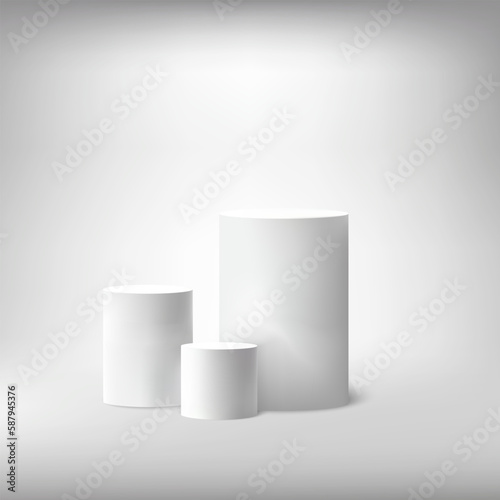 Realistic white empty round podiums. Minimal scene for product demonstration. Abstract scene with cylindrical podiums. © lesikvit