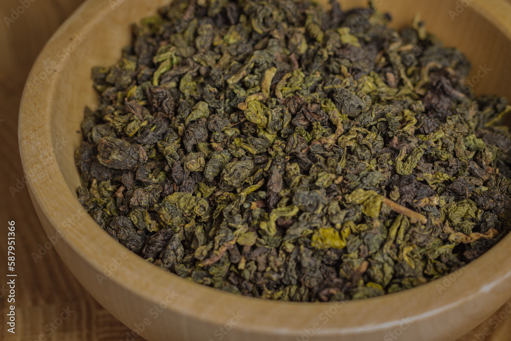 tea leaves on a rustic background. black tea, milk oolong, tea blend. Tea in wooden bowls