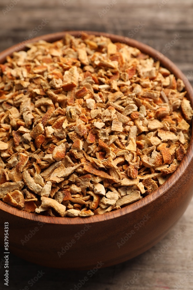 Bowl of dried orange zest seasoning on wooden table, closeup Bowl of dried orange zest seasoning on wooden table, closeup