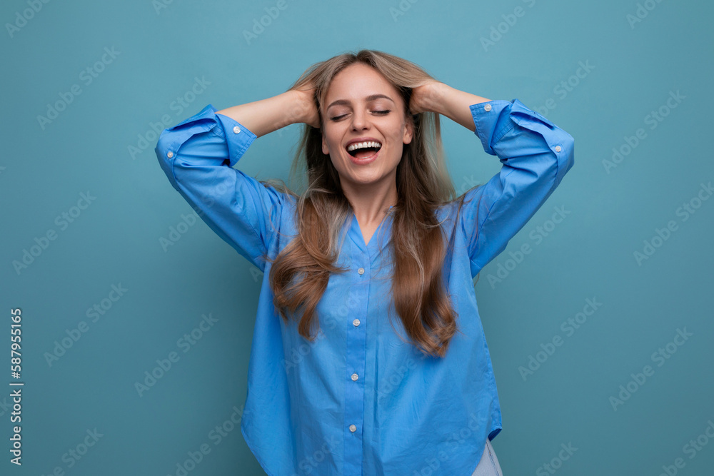 photo of adorable young woman dreaming on blue background with blank space photo of adorable young woman dreaming on blue background with blank space