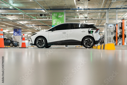 Charging of electric cars at a charging station, automotive industry, transportation © Naypong Studio