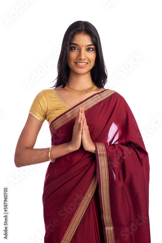 Canvas Print Pretty Indian young girl gesturing in traditional saree on white.