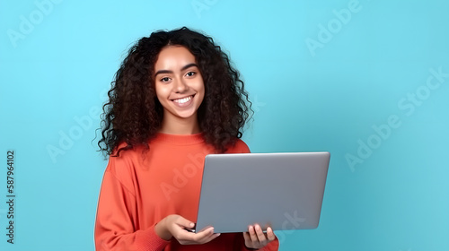 young latin woman smiling, working on her laptop © Demencial Studies