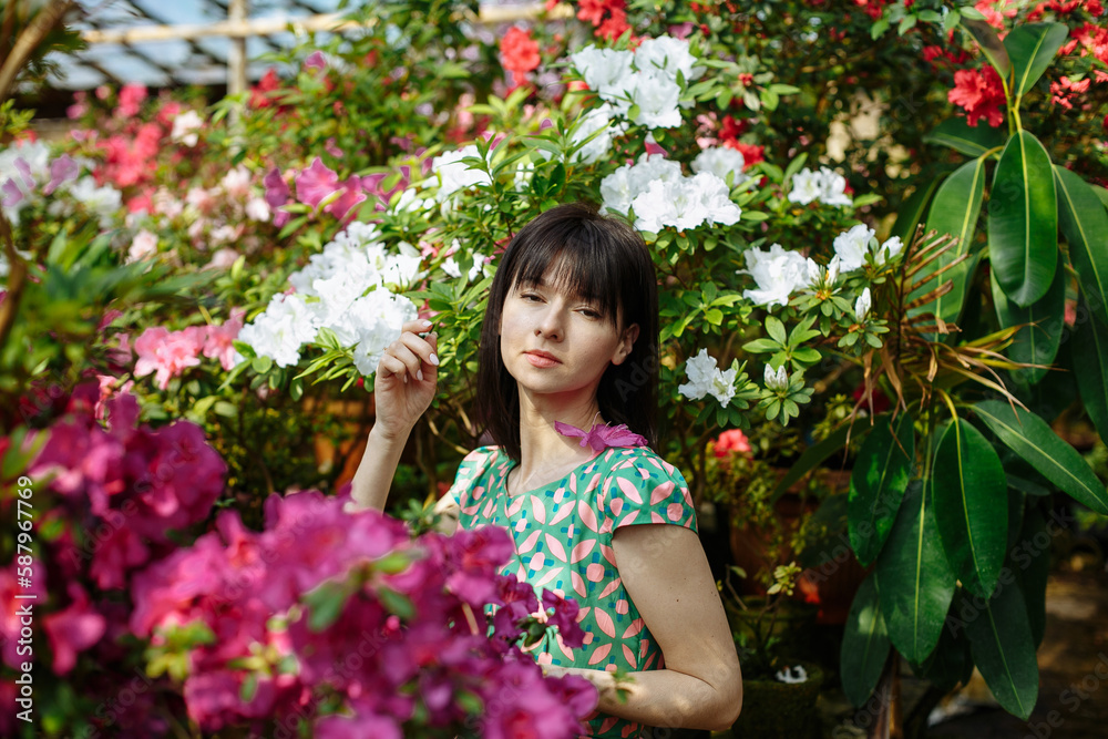 A girl in a green dress in a flower park on a sunny day A girl in a green dress in a flower park on a sunny day