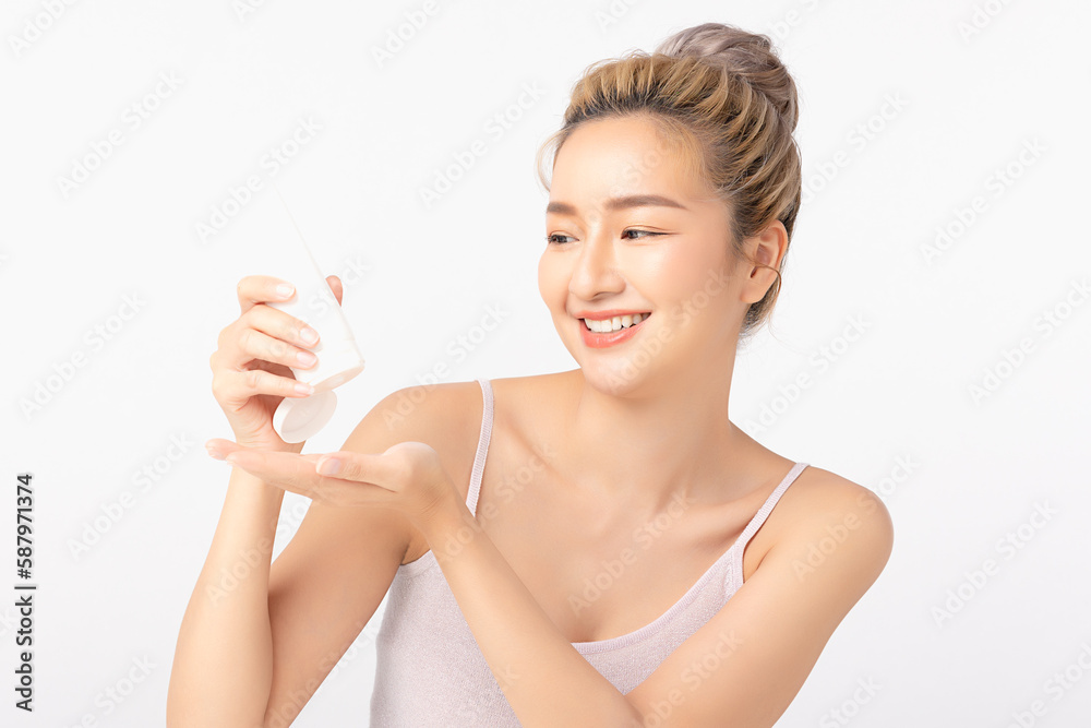 Happy beautiful young asian woman holding cosmetic cream blank bottle, Fashion model, Health wellness, Beautiful girl skin care and facial treatment. Isolated on white background. Happy beautiful young asian woman holding cosmetic cream blank bottle, Fashion model, Health wellness, Beautiful girl skin care and facial treatment. Isolated on white background.