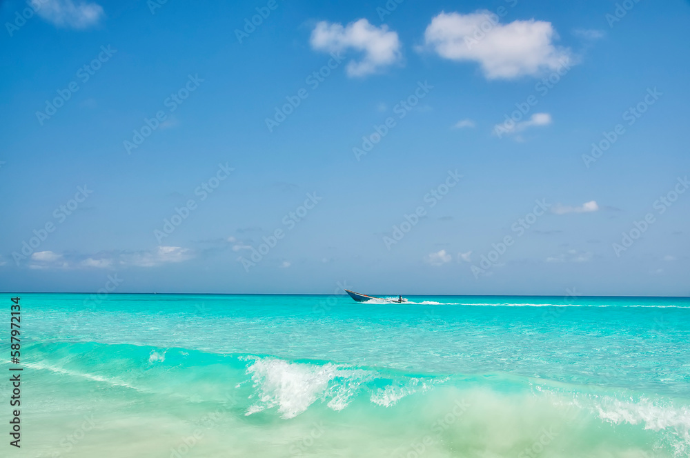 Fishing boat on the waves of the Indian Ocean in the emerald water. Fishing boat on the waves of the Indian Ocean in the emerald water.