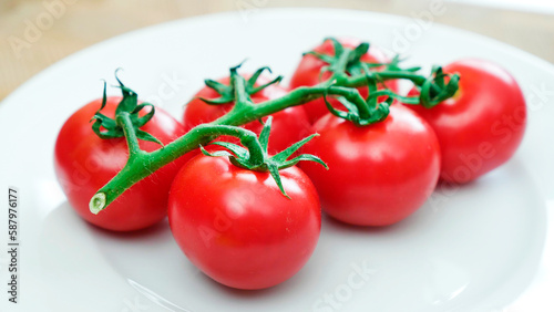 tomatoes with a sprig on a white plate