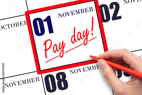 Hand writing text PAY DATE on calendar date November 1 and underline it. Payment due date