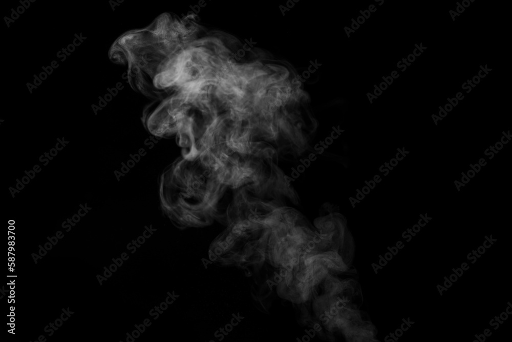 White curling dense smoke steam rising up is isolated on black background to overlay your photos. White curling dense smoke steam rising up is isolated on black background to overlay your photos.