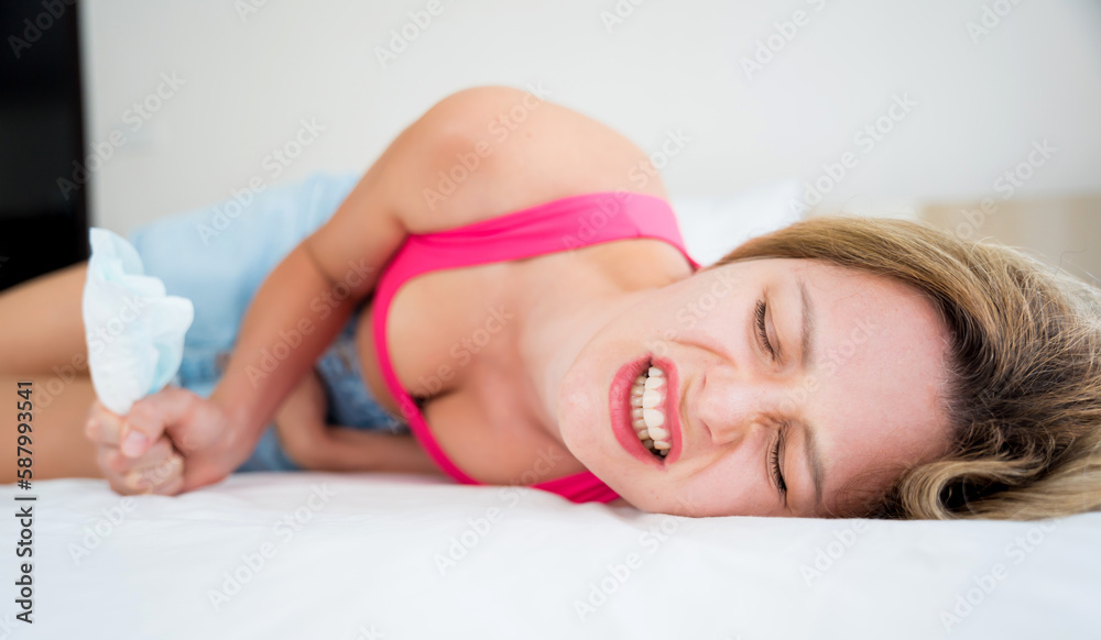 beautiful woman feels pain during menstruation on the bed beautiful woman feels pain during menstruation on the bed