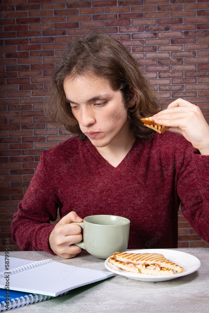 Morning, a young attractive guy has breakfast. Morning, a young attractive guy has breakfast.