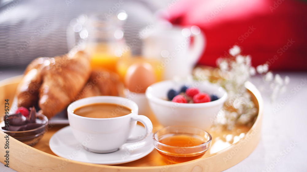 A tray with breakfast on a bed in a hotel room A tray with breakfast on a bed in a hotel room