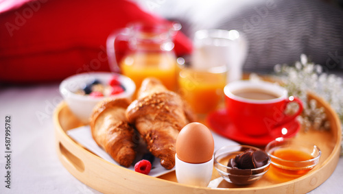 A tray with breakfast on a bed in a hotel room