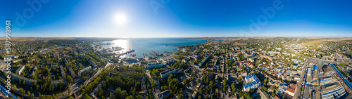 Kerch, Crimea - August 31, 2020: Panorama of the city, port and Crimean bridge aerial view. Panorama 360