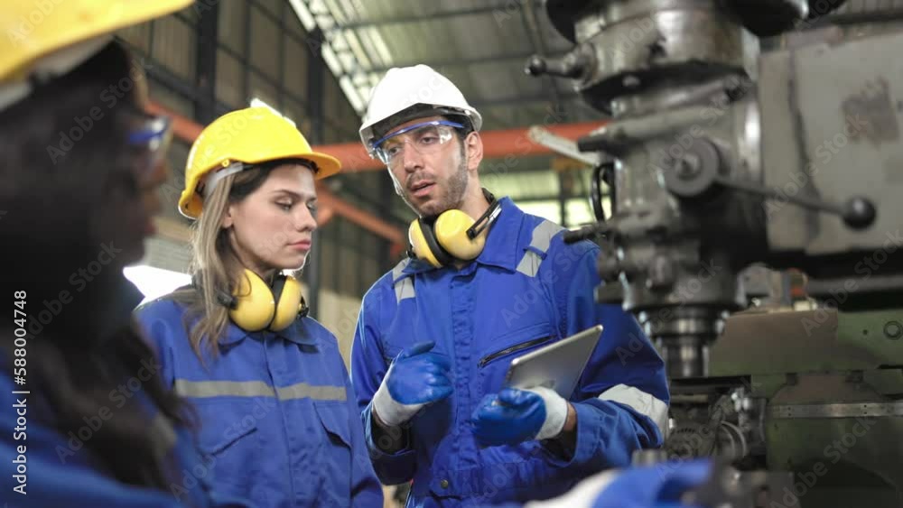 Young people worker in protective uniform operating machine at factory Industrial.People working in industry.Portrait of Female Engineer looking camera at work place... Young people worker in protective uniform operating machine at factory Industrial.People working in industry.Portrait of Female Engineer looking camera at work place...